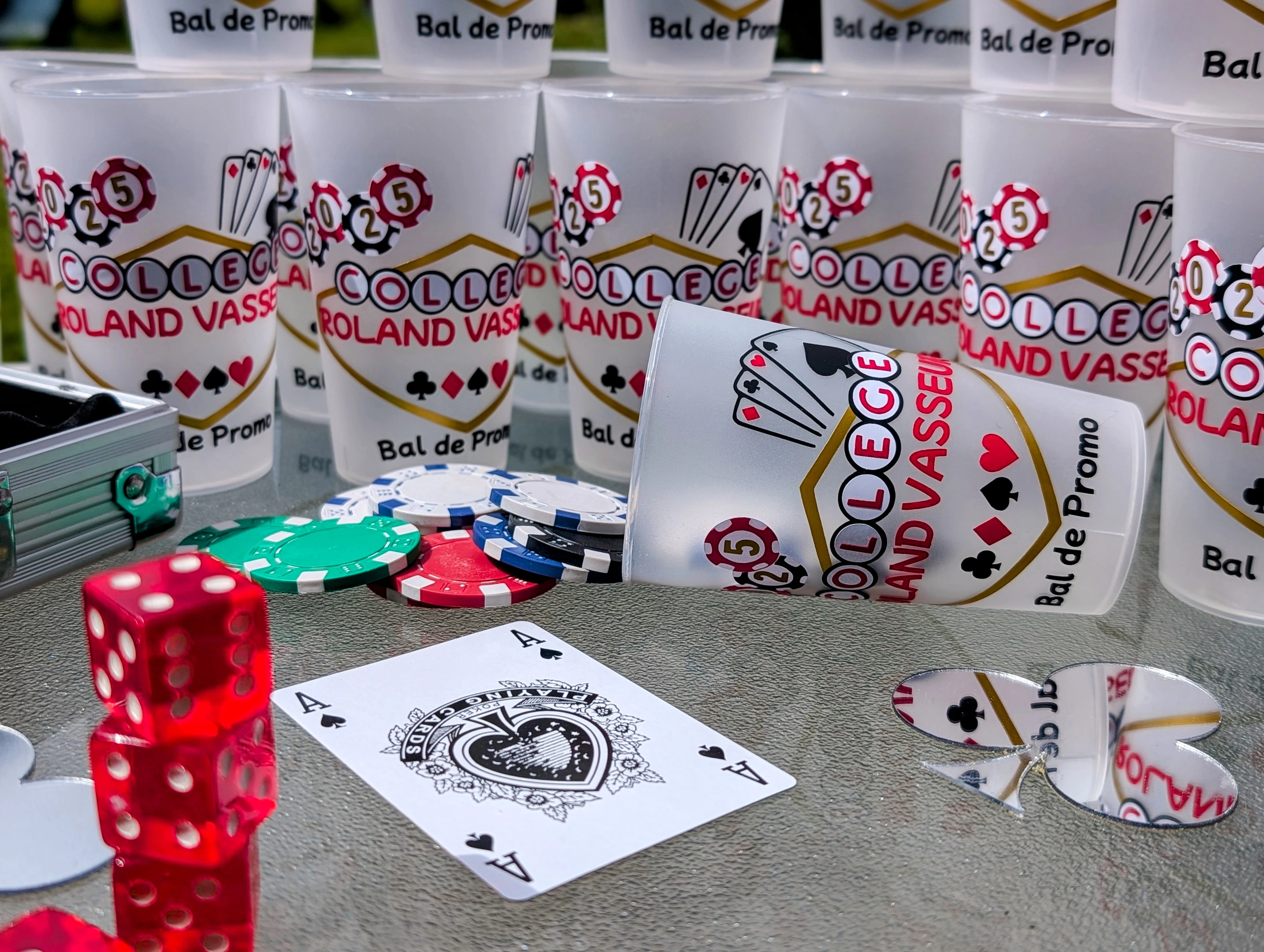 A group of friends laughing and celebrating a birthday with cake and confetti.